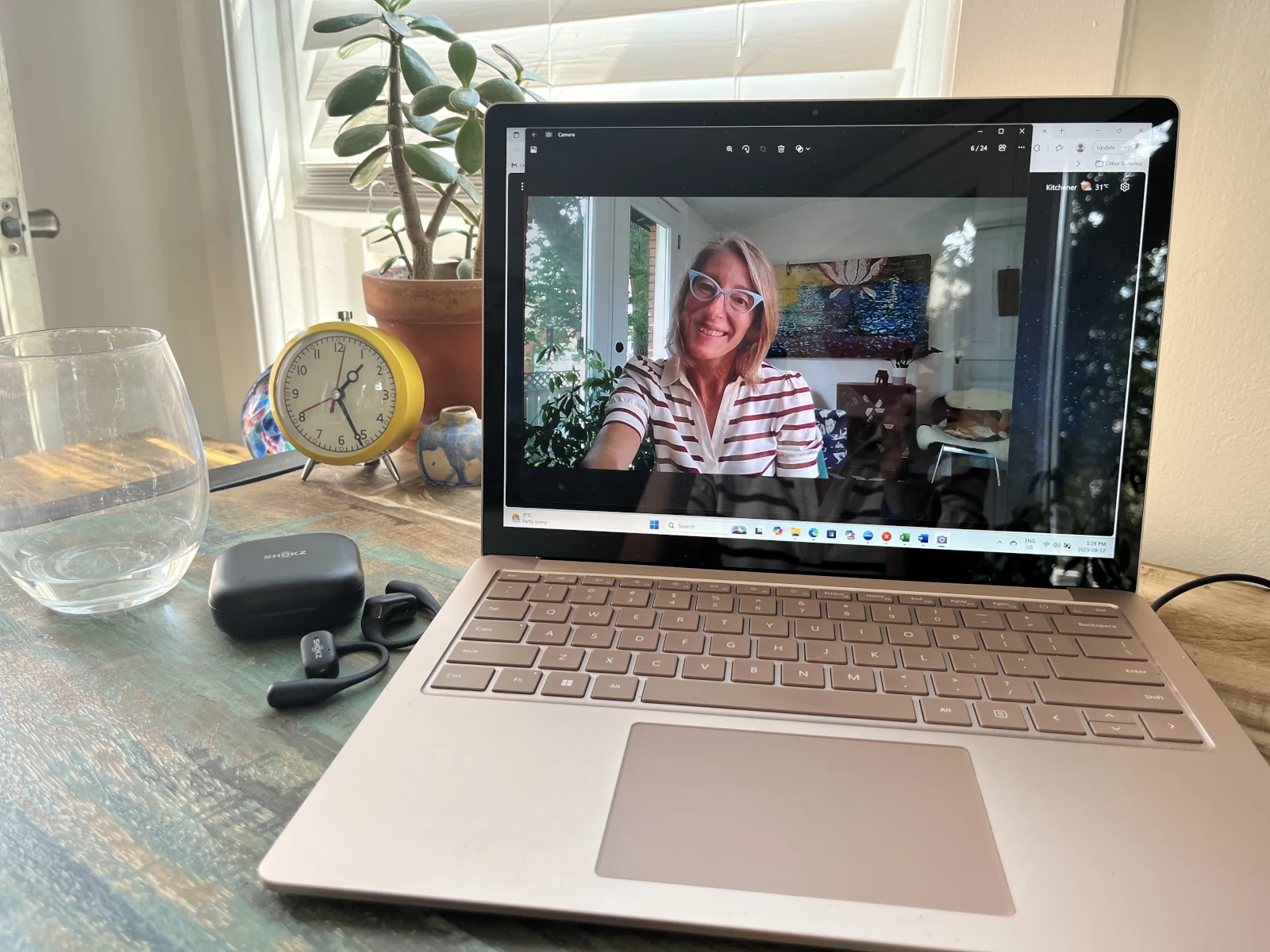 Jen taking a video call on her laptop from her office